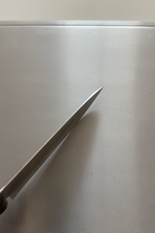 Knife on titanium cutting board