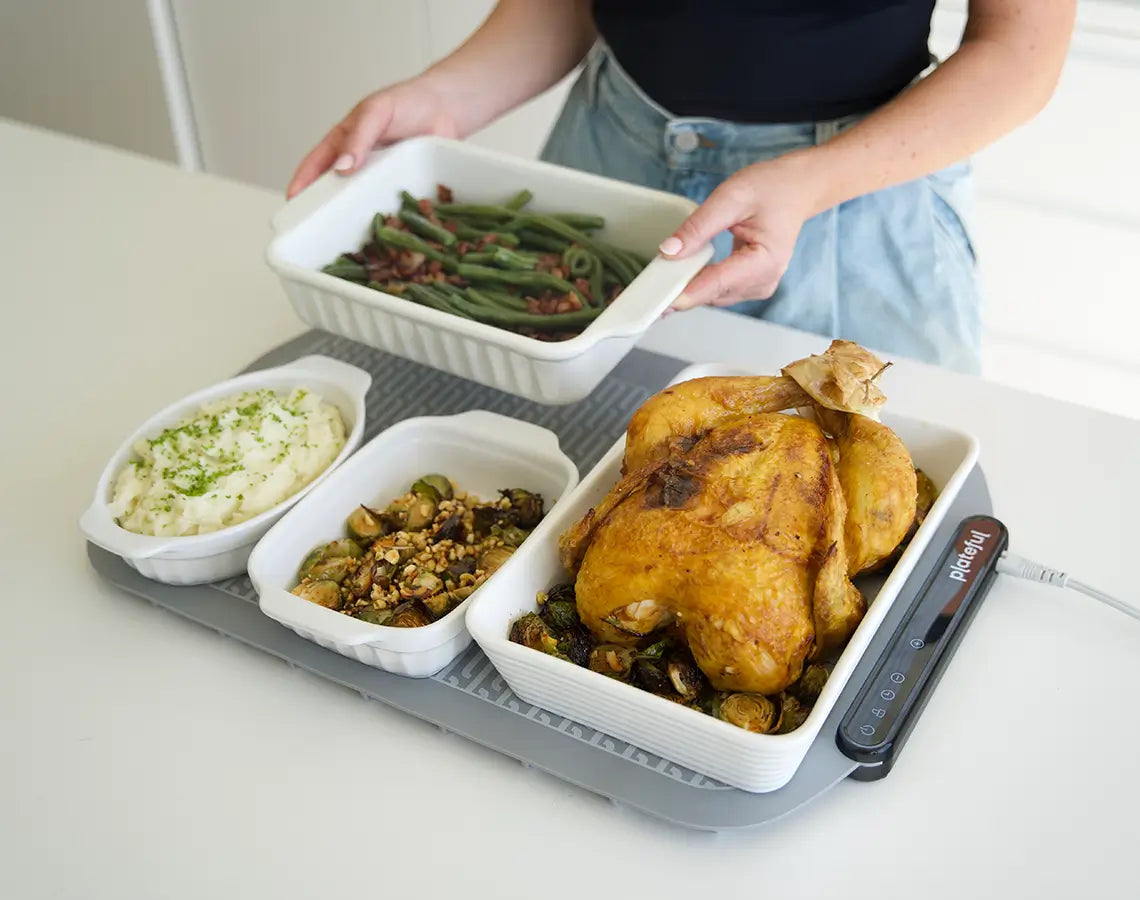 A food warming mat arranged for a shared meal